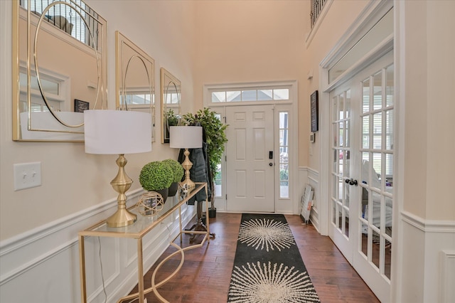825 Burch Creek Dr, Grovetown, GA 30813 - foyer entrance featuring french doors, wood finished floors, a high ceiling, wainscoting, and a decorative wall