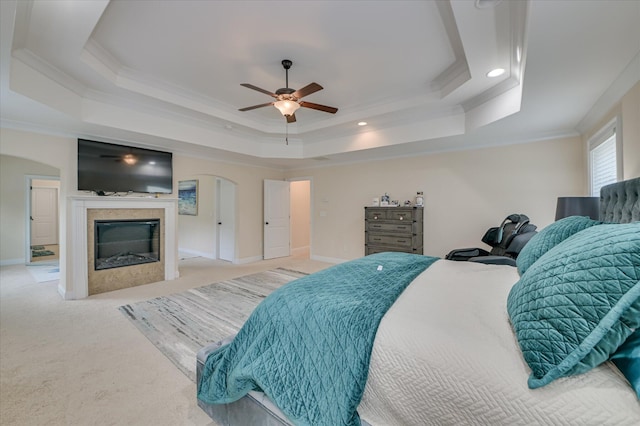 825 Burch Creek Dr, Grovetown, GA 30813 - carpeted bedroom with a tray ceiling, crown molding, a glass covered fireplace, arched walkways, and recessed lighting
