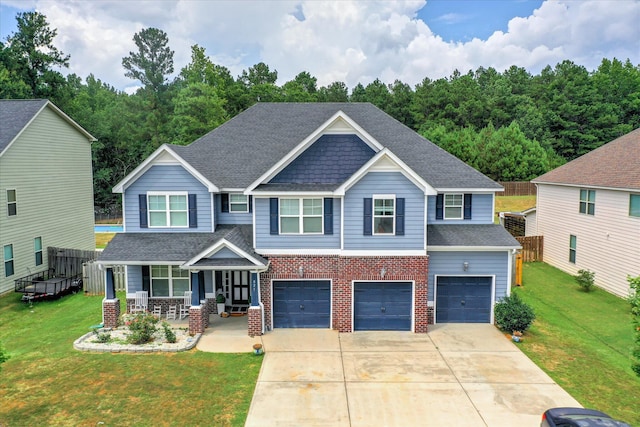 825 Burch Creek Dr, Grovetown, GA 30813 - craftsman-style house featuring covered porch, an attached garage, brick siding, concrete driveway, and roof with shingles