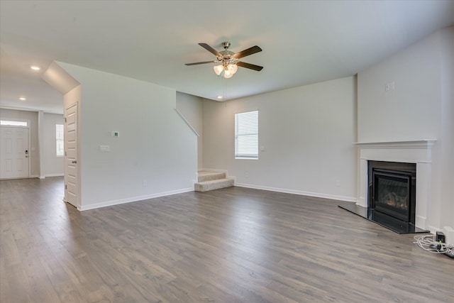 830 Otto Run, North Augusta, SC 29860 - unfurnished living room featuring a glass covered fireplace, a ceiling fan, dark wood-style flooring, healthy amount of natural light, and recessed lighting