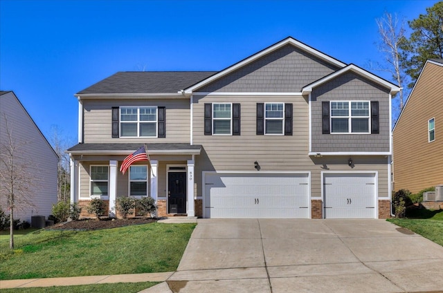 craftsman house featuring brick siding, an attached garage, central AC unit, a front yard, and driveway