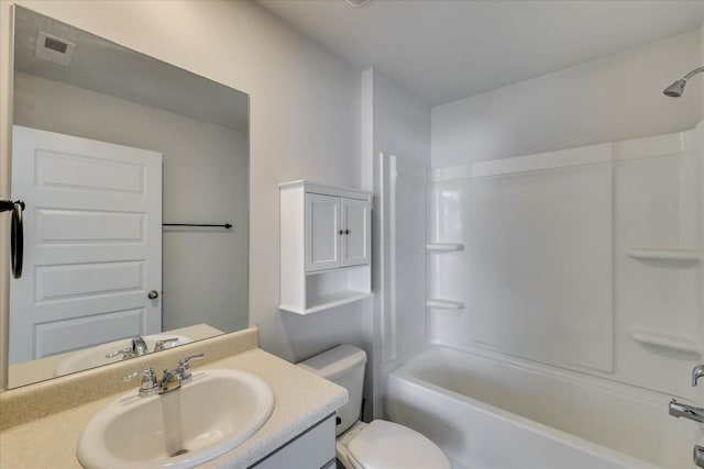 bathroom featuring toilet, visible vents, vanity, and bathing tub / shower combination