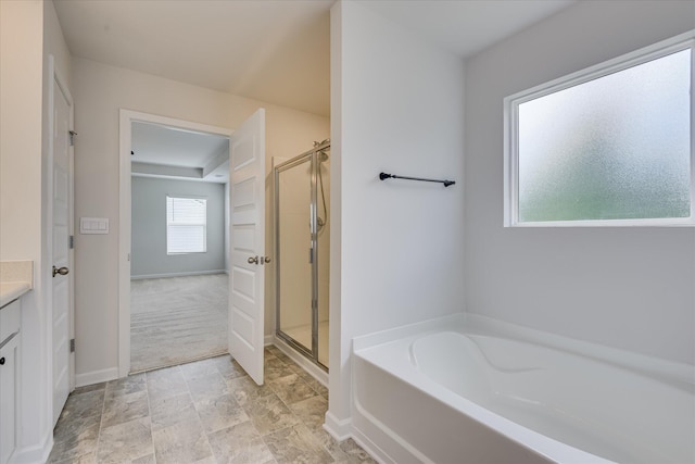 830 Otto Run, North Augusta, SC 29860 - bathroom featuring a garden tub, a shower stall, vanity, baseboards, and stone finish floors