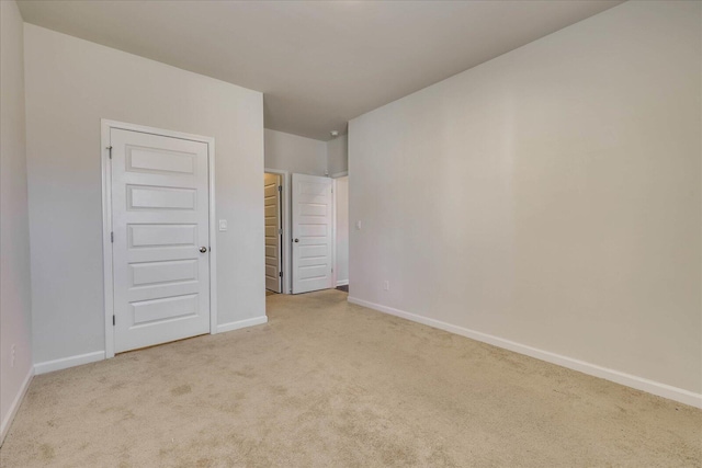 interior space with light colored carpet and baseboards