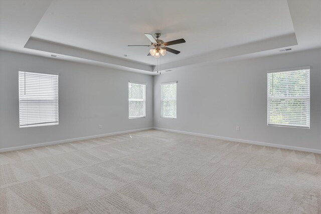 830 Otto Run, North Augusta, SC 29860 - unfurnished room with a raised ceiling, ceiling fan, baseboards, light colored carpet, and plenty of natural light