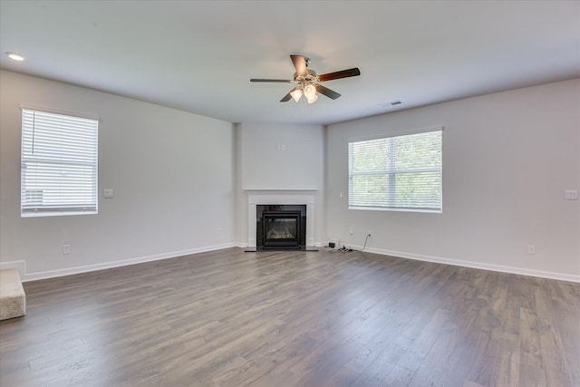 830 Otto Run, North Augusta, SC 29860 - unfurnished living room featuring a glass covered fireplace, dark wood-style flooring, ceiling fan, baseboards, and recessed lighting