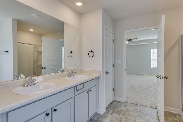 830 Otto Run, North Augusta, SC 29860 - full bathroom with double vanity, baseboards, a shower stall, ceiling fan, and stone finish floors