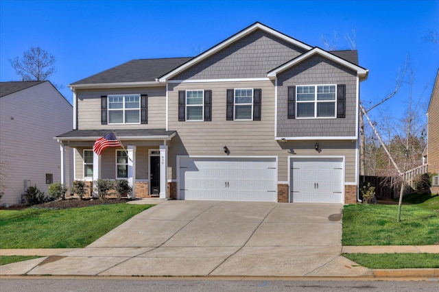 craftsman inspired home with an attached garage, a front lawn, concrete driveway, and brick siding