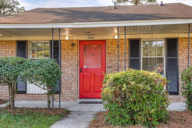 view of exterior entry featuring covered porch