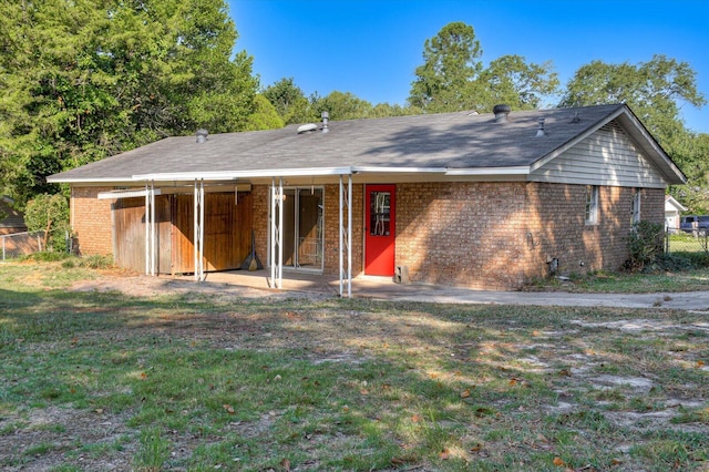 rear view of house with a yard