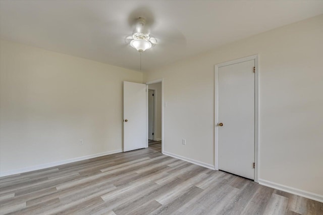 spare room featuring light wood-type flooring and ceiling fan