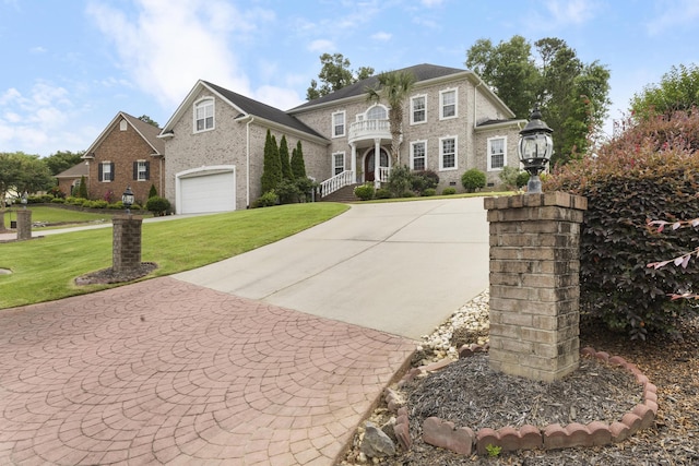 112 Bridge Crest Ct, Aiken, SC 29803 - georgian-style home with a front lawn, concrete driveway, brick siding, and a balcony