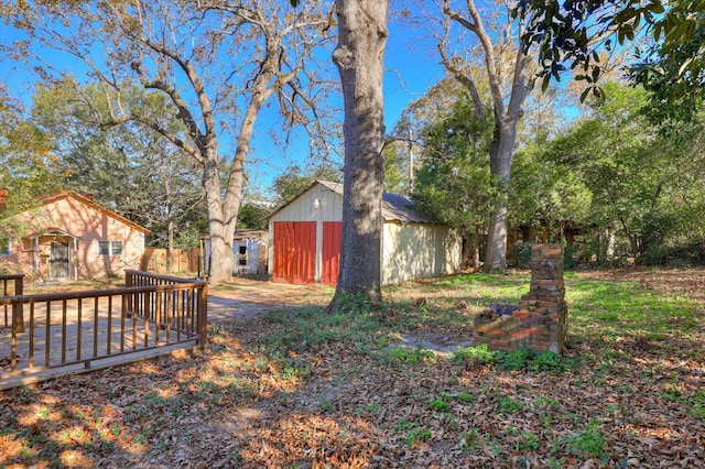 view of yard with an outbuilding and a wooden deck