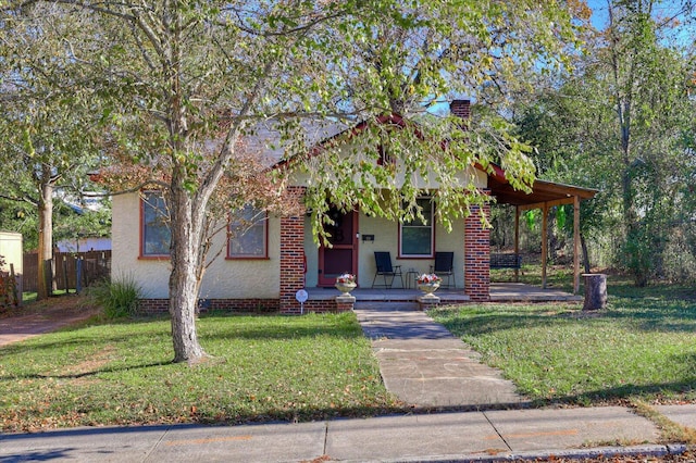 view of front of house with covered porch and a front lawn