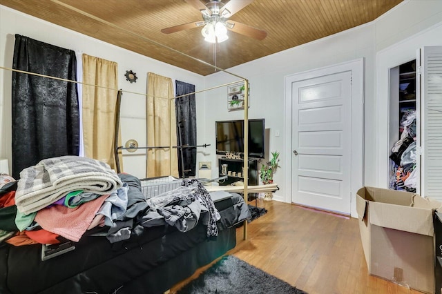 bedroom with ceiling fan, hardwood / wood-style floors, and wood ceiling