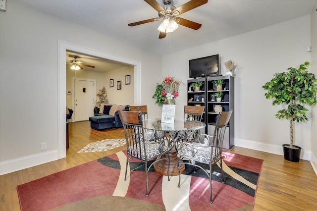 dining space featuring ceiling fan and hardwood / wood-style flooring