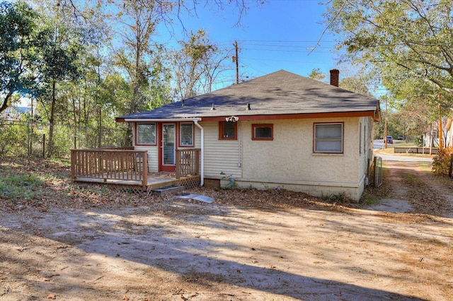 rear view of property with a wooden deck