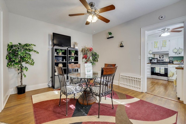 dining area featuring ceiling fan and light wood-type flooring