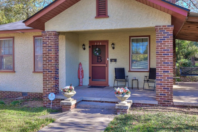 entrance to property featuring a porch