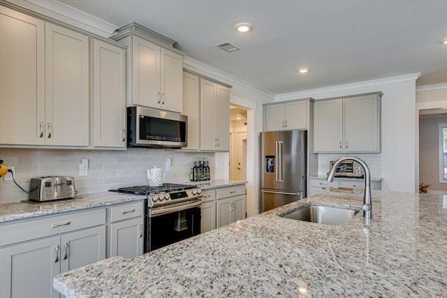 kitchen with light stone countertops, sink, tasteful backsplash, crown molding, and appliances with stainless steel finishes