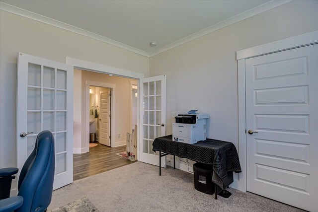 carpeted office space featuring ornamental molding and french doors