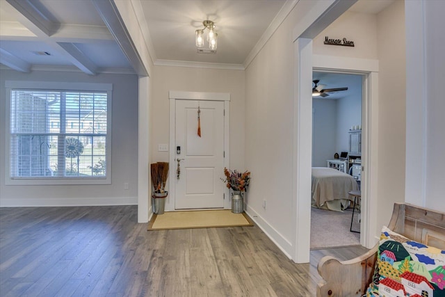 entryway featuring coffered ceiling, crown molding, hardwood / wood-style flooring, ceiling fan, and beamed ceiling