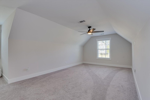 additional living space featuring light carpet, vaulted ceiling, and ceiling fan