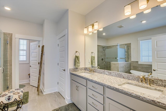 bathroom featuring vanity and shower with separate bathtub