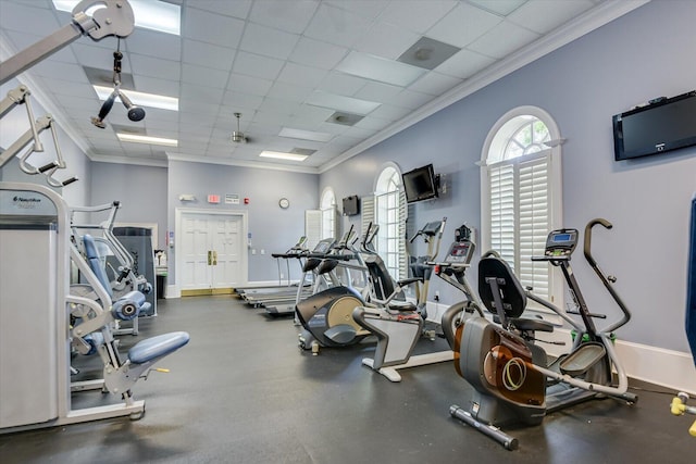 workout area featuring a drop ceiling and ornamental molding