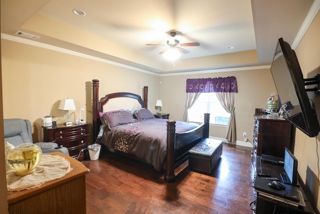 bedroom with visible vents, a raised ceiling, and wood finished floors