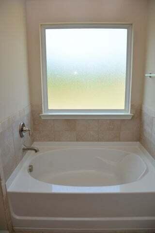 bathroom with a bathtub and plenty of natural light