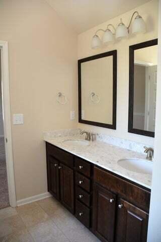 bathroom with tile patterned floors and vanity