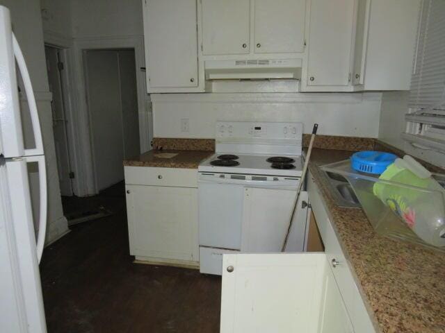 kitchen featuring white cabinets, white appliances, and range hood