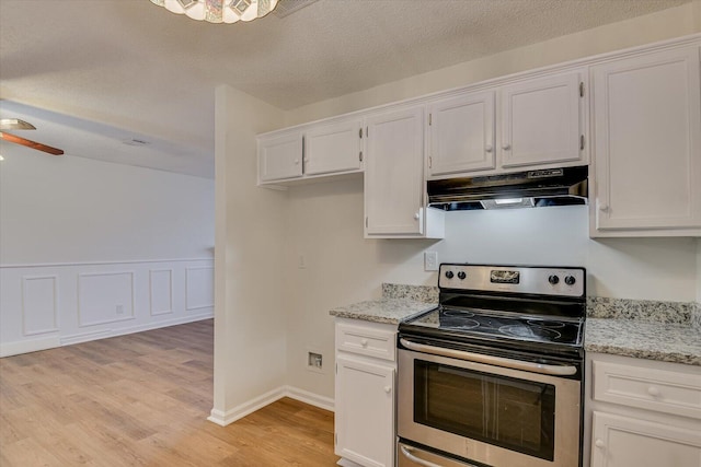 kitchen featuring white cabinets, stainless steel range with electric stovetop, ceiling fan, and light stone counters