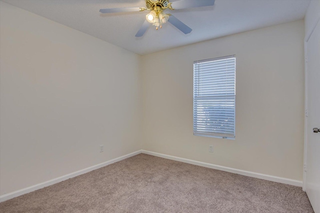 spare room with light carpet and ceiling fan