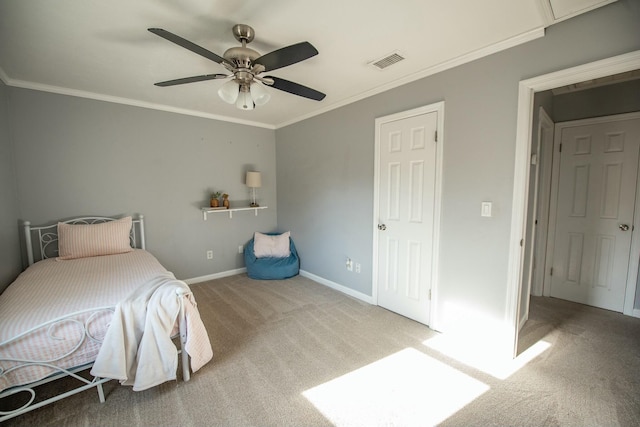 bedroom with ceiling fan, carpet floors, and crown molding