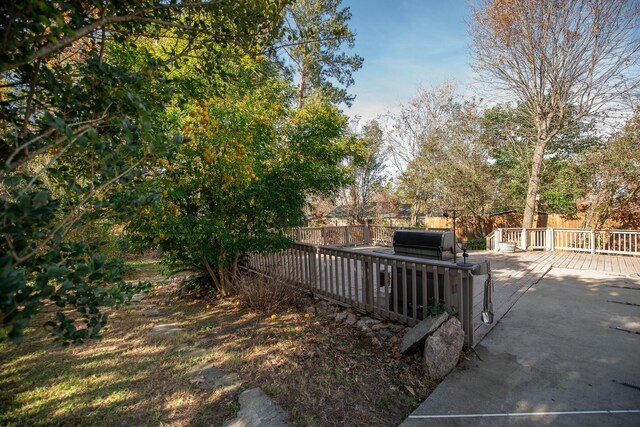 view of gate with a patio and a deck