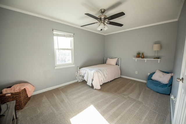 carpeted bedroom with ceiling fan and crown molding