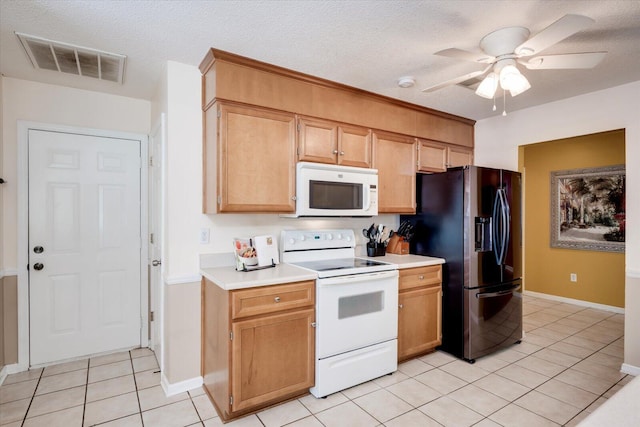 kitchen featuring visible vents, light tile patterned floors, light countertops, a ceiling fan, and white appliances