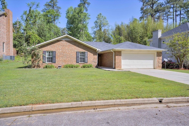 single story home with a garage, a front yard, brick siding, and driveway