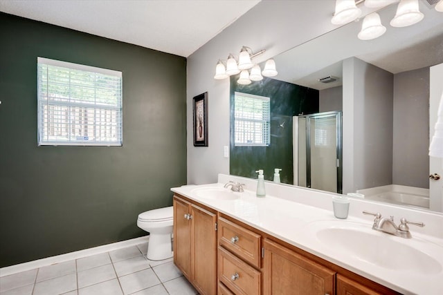 full bathroom with a shower stall, tile patterned floors, double vanity, and a sink