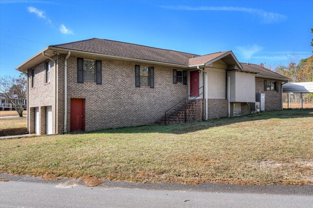 view of front of house with a front yard, a garage, and a carport