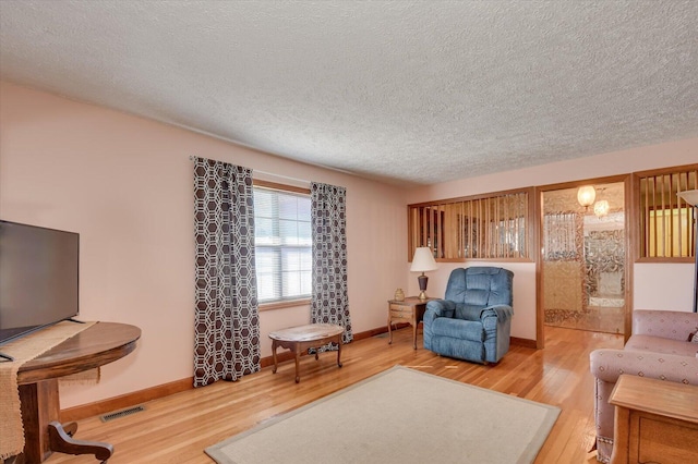 living room featuring a textured ceiling and hardwood / wood-style flooring