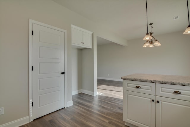 4062 Cottingham Way, Augusta, GA 30909 - kitchen with dark wood finished floors, white cabinetry, pendant lighting, baseboards, and a chandelier