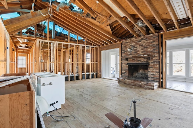 unfurnished living room with lofted ceiling and a fireplace