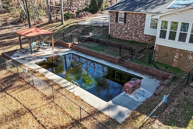 view of swimming pool with a gazebo, stairway, a patio area, and fence