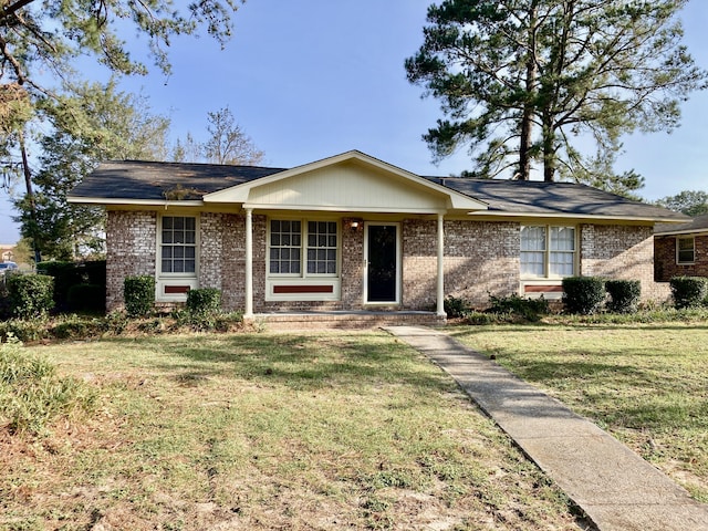 single story home featuring a front lawn