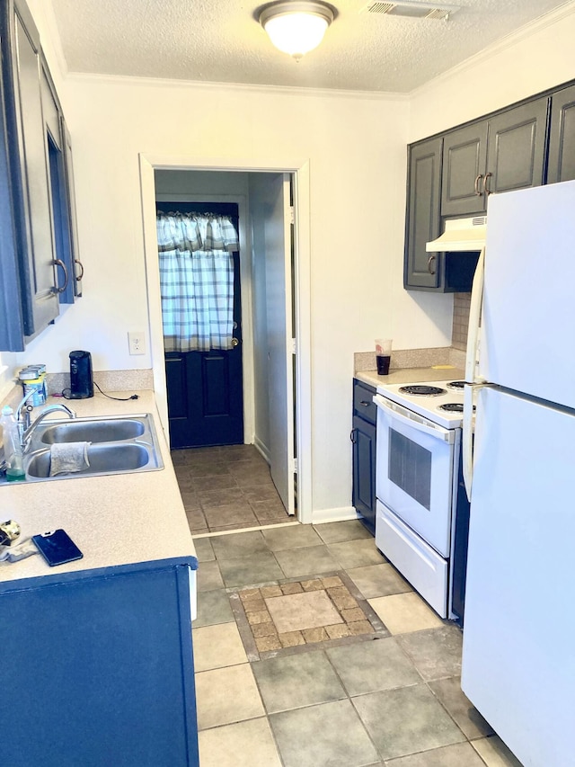 kitchen with sink, white appliances, and a textured ceiling