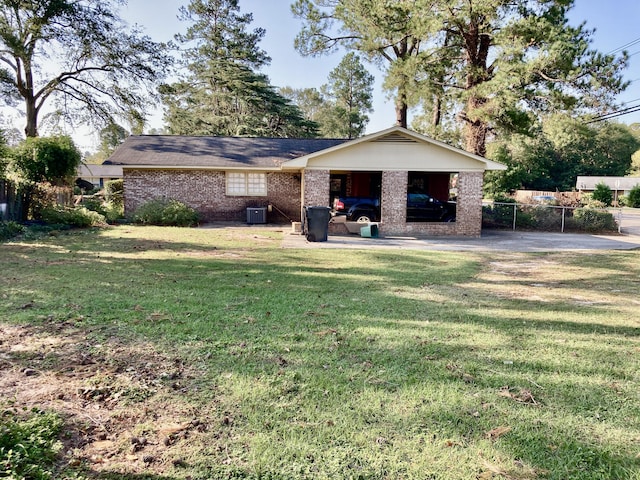 rear view of house featuring a yard, a patio area, and central AC unit