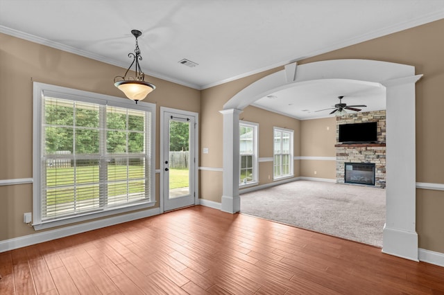 436 Sebastian Dr, Grovetown, GA 30813 - unfurnished living room featuring a ceiling fan, a stone fireplace, ornate columns, arched walkways, and ornamental molding